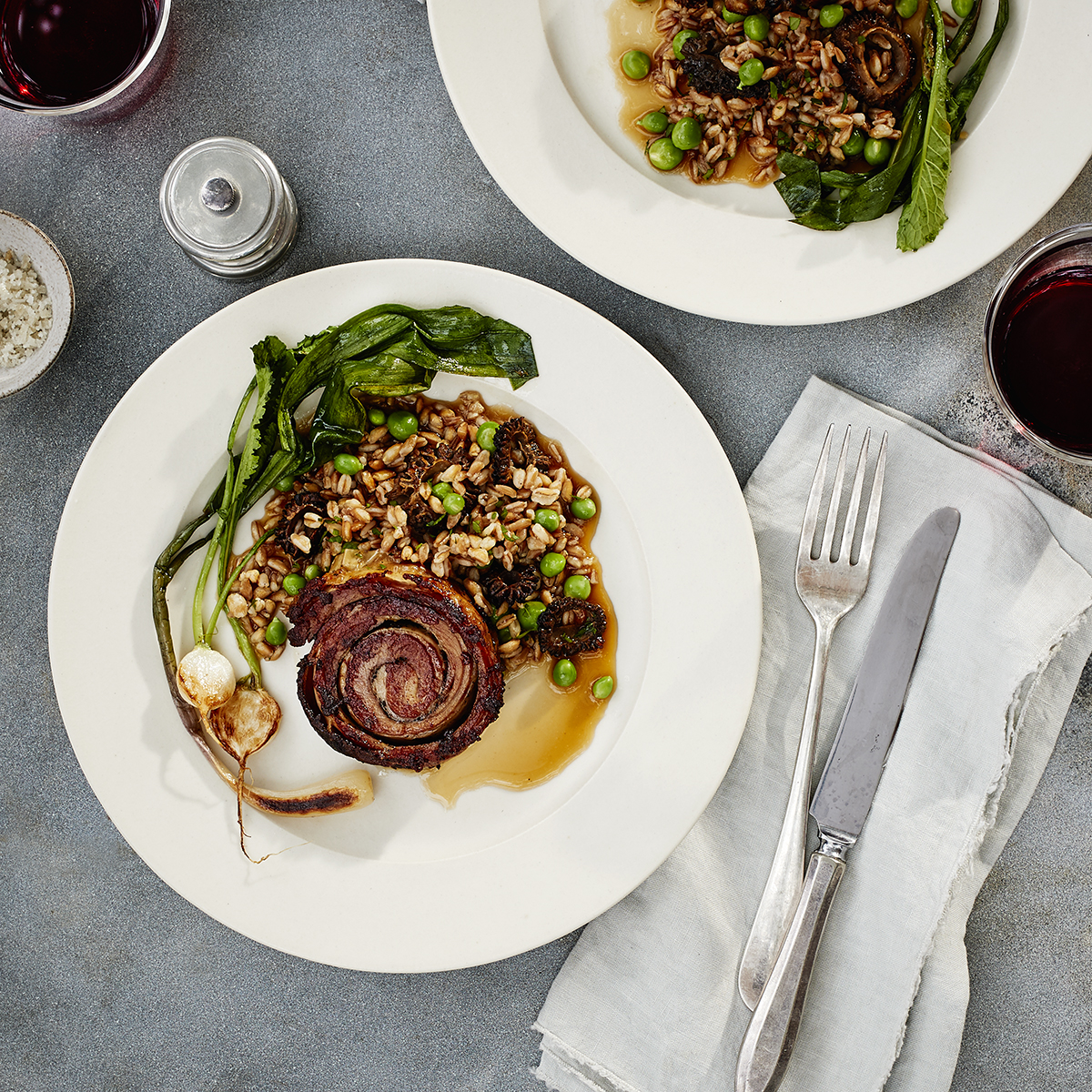 Two plates of lamb Belly (Braised) with Farro, Seared Turnips & Ramps